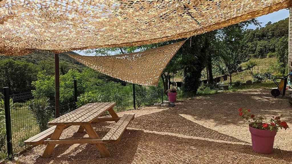 Terraza cubierta con un toldo de camuflaje.