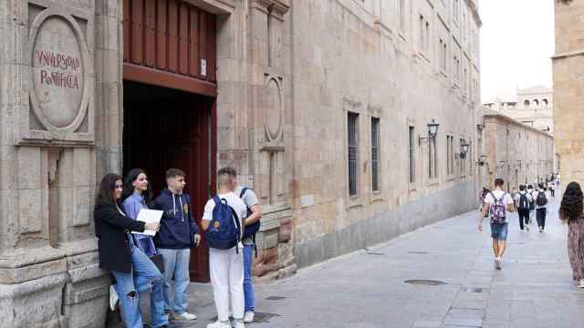 Estudiantes esperan en la puerta de la Universidad Pontificia de Salamanca
