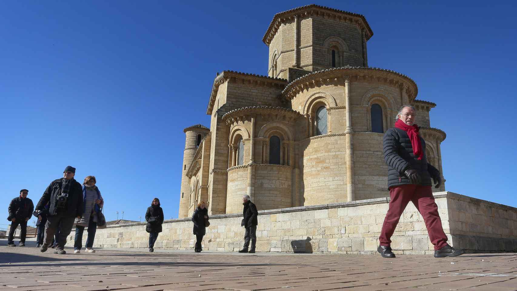 Unos ciudadanos andando por las inmediaciones de la iglesia de San Martín