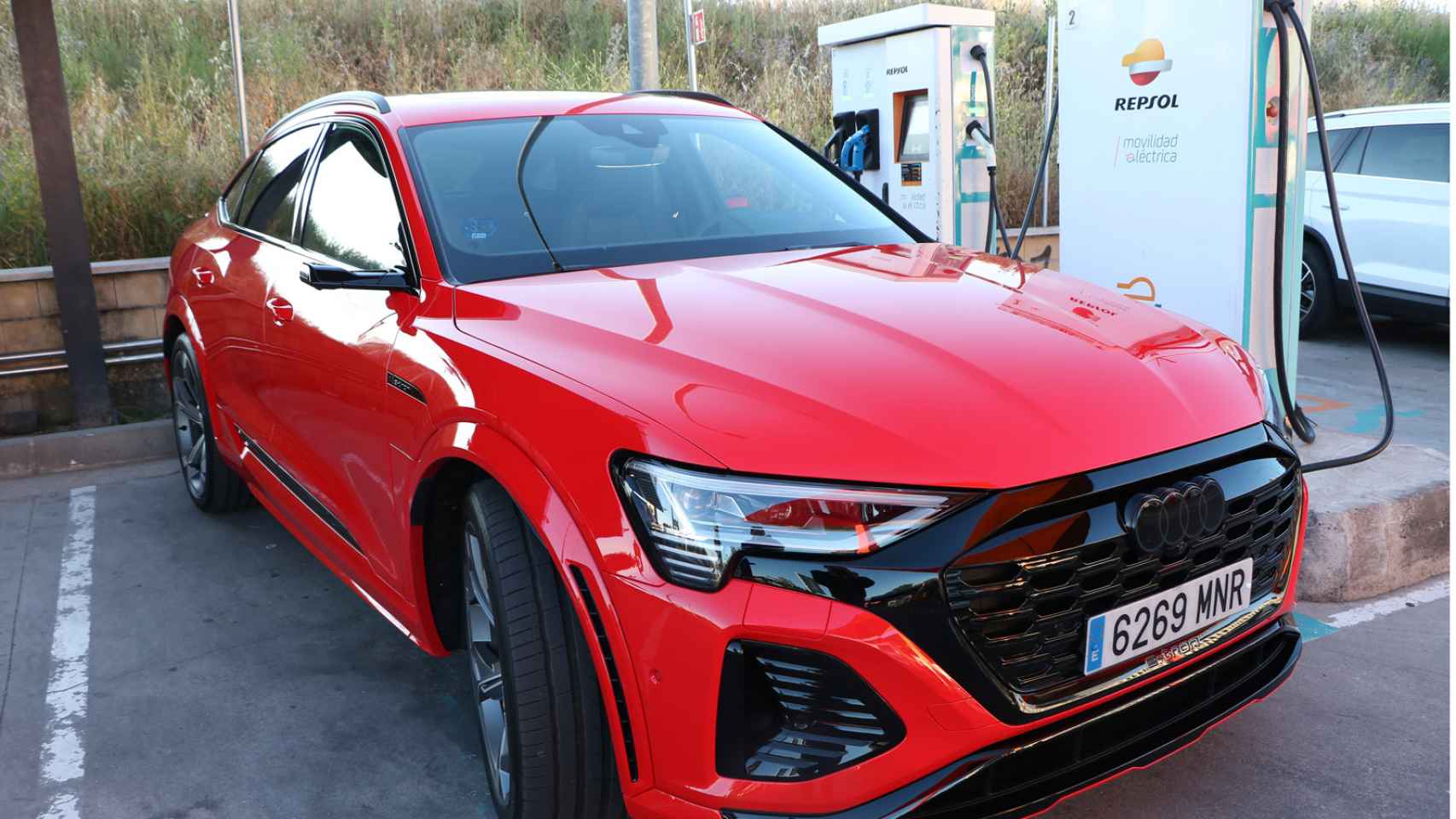 El coche eléctrico Audi Q8 e un punto de recarga de Repsol en Madrid.