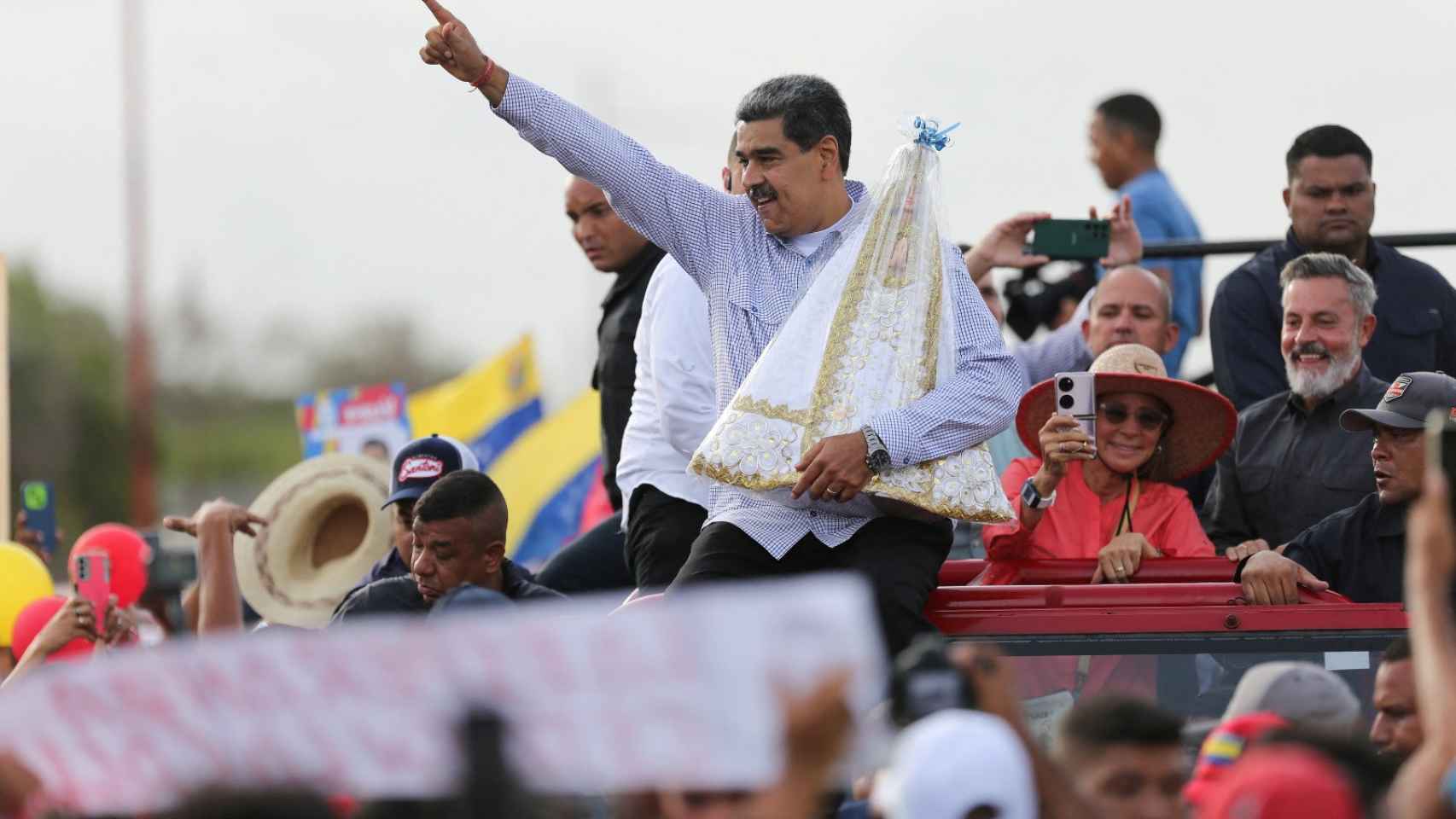 El presidente de Venezuela, Nicolás Maduro, carga una estatua religiosa mientras llega a Nueva Esparta.
