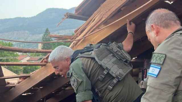 Miembros de las Fuerzas de Israel inspeccionan una de las casas afectadas por los cohetes de Hezbolá.