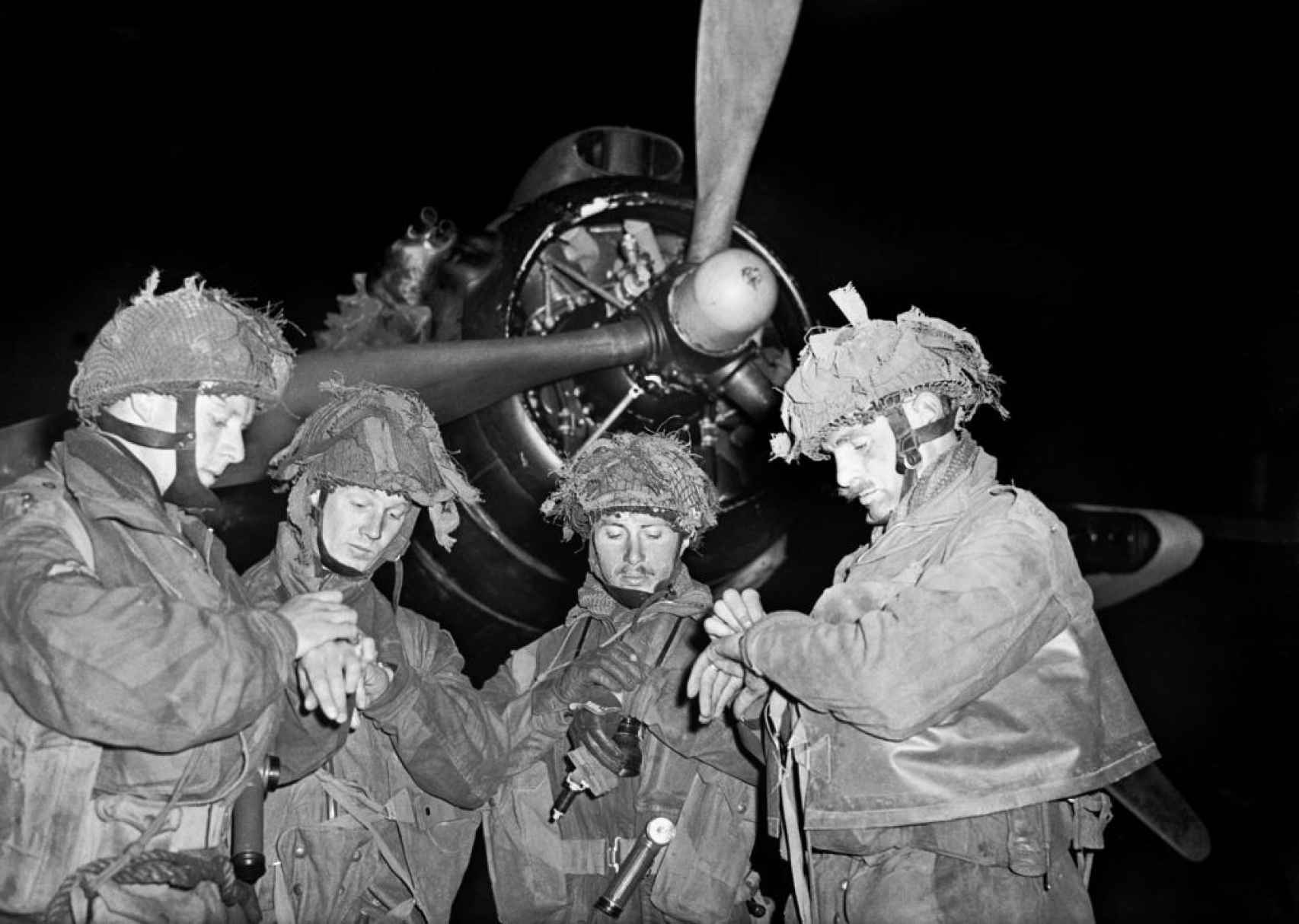 Paracaidistas británicos sincronizando sus relojes en la noche del 5 de junio.