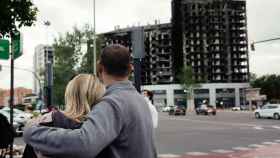 Una pareja, frente al edificio incendiado de Campanar (Valencia).