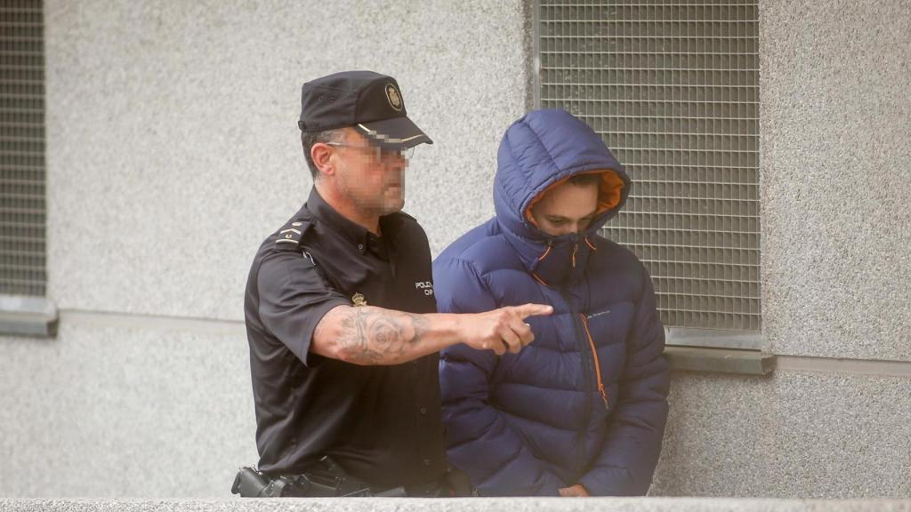 Un agente de Policía acompaña al lotero detenido a su llegada al Juzgado