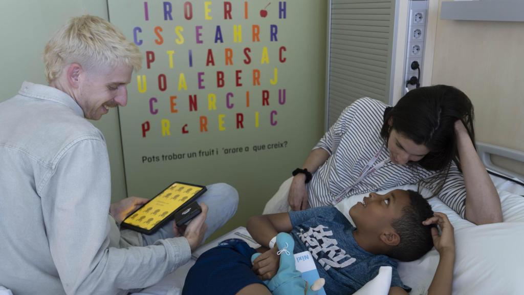 Tomàs Lóbez Pérez, CEO y fundador de Nixi for Children; Sònia Tordera, coordinadora del equipo Child Life del Hospital Sant Joan de Déu junto a un paciente pediátrico.