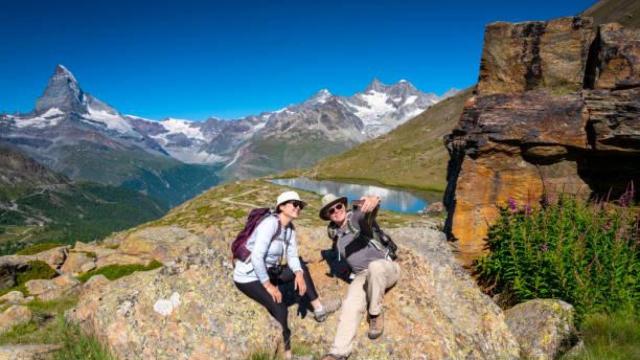 Una pareja de jubilados se hacen un selfie en un lago de Suiza.