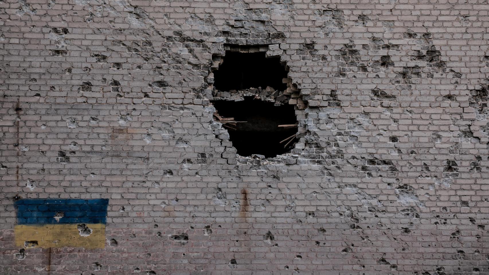 Imagen de la fachada de un edificio completamente acribillada en el frente de Donetsk.