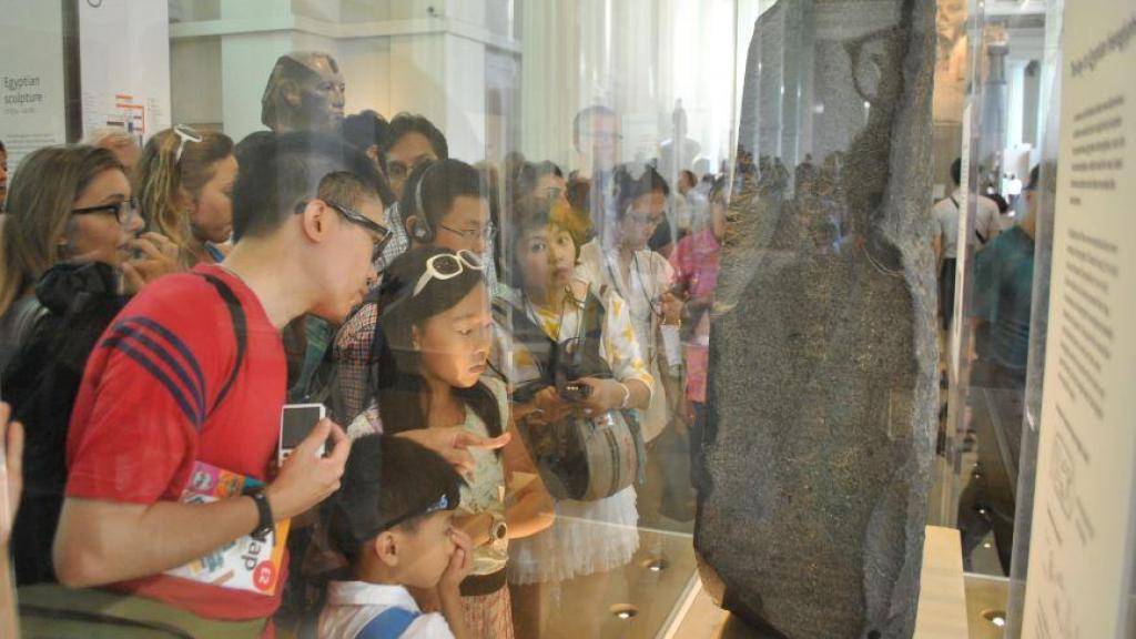 Un grupo de turistas observa las inscripciones de la Piedra de Rosetta en el British Museum