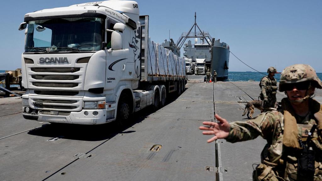 Un camión transporta ayuda humanitaria a la Franja de Gaza a través del muelle Trident.
