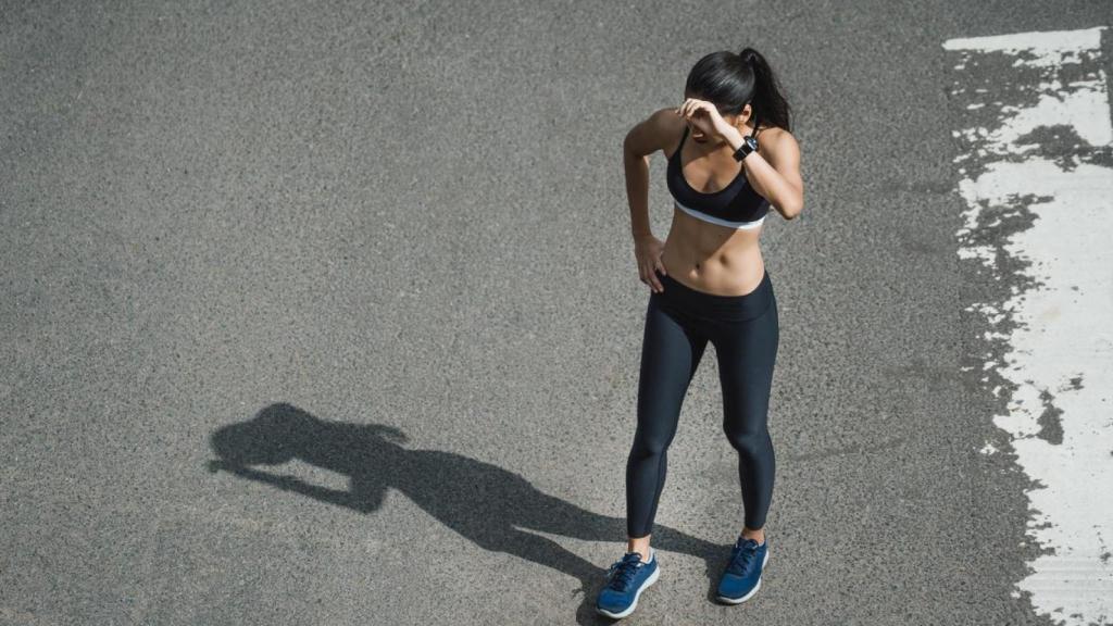 Mujer deportista reflejada en el asfalto.