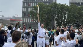 Pau Gasol posa levantando la antorcha olímpica.