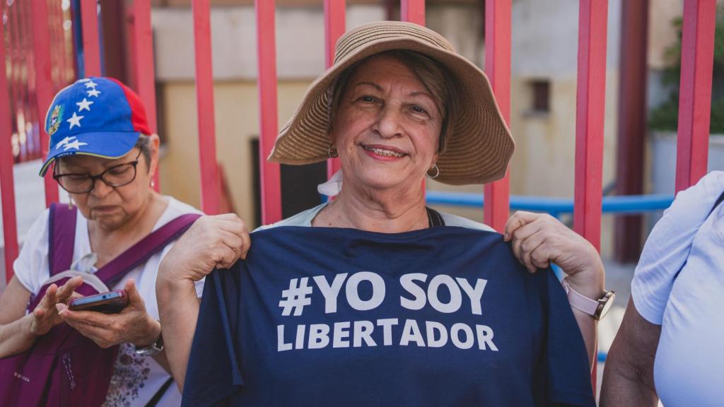 Una electora sostiene una camiseta en la que puede leerse Yo soy libertador.