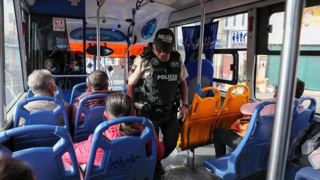 Un policía realiza un control en el interior de un autobús, en Ecuador.