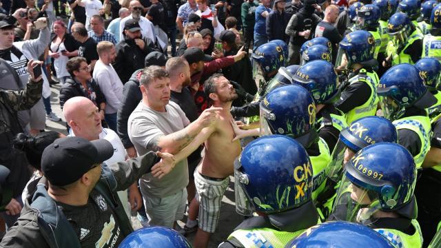 Manifestantes se enfrentan a agentes de policía en Manchester, Gran Bretaña.