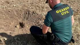 Un agente de la Guardia Civil junto al artefacto explosivo.