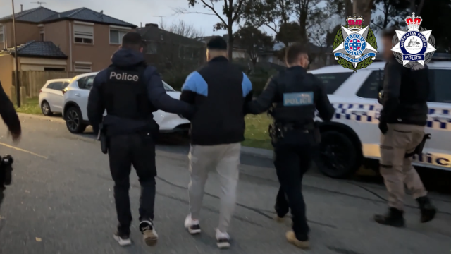 La Policía australiana se lleva a un hombre detenido en el marco de la operación contra la plataforma 'Ghost'.