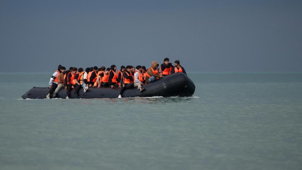 Migrants in an inflatable boat attempt to cross the English Channel to reach Britain, at Slack Dunes beach in Wimereux, France, in September 2024.