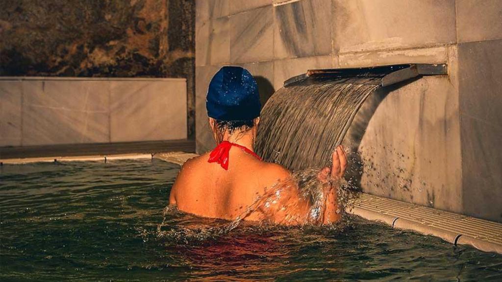 Mujer bañándose en aguas termales de Baños de Montemayor.