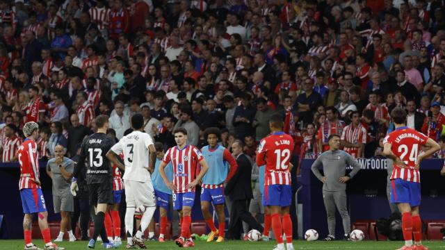 Jugadores del Atlético y del Real Madrid durante el parón en el derbi madrileño