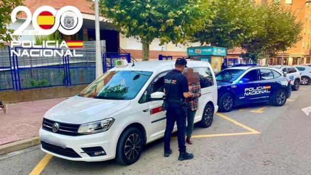 Un Policía Nacional toma testimonio al taxista.