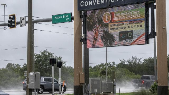 Varios vehículos circulan en la carretera bajo la lluvia del huracán Milton.