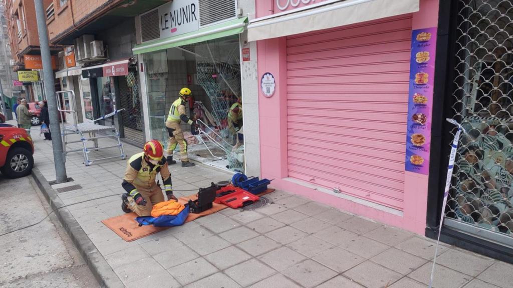 Bomberos del Ayuntamiento de Toledo trabajando en la tienda donde se ha producido el choque.