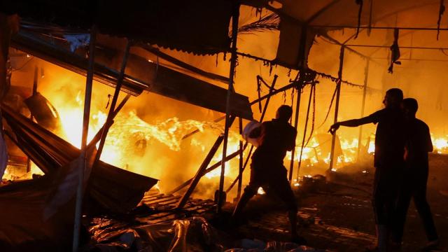 Varias personas tratan de extinguir el fuego tras el ataque israelí en Deir Al-Balah, en el centro de Gaza.