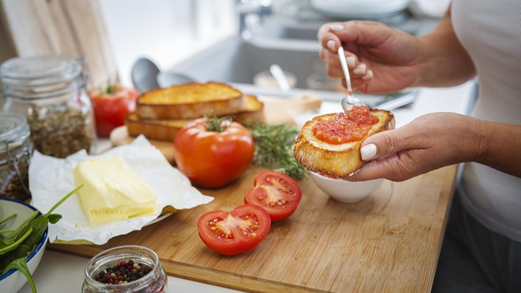 Mujer preparándose unas tostadas para el desayuno.