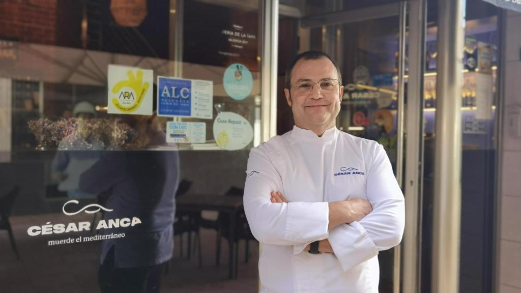 César Anca, ante la puerta de su local en Alicante.