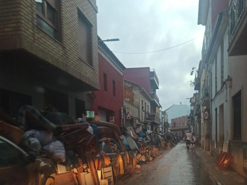 Montañas y montañas de enseres arrasados por la riada, apilados en la calle de uno de los pueblos de la zona cero de la DANA, a la espera de que la maquinaria los pueda retirar.