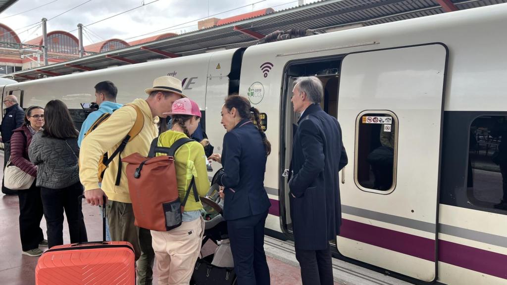 Un grupo de pasajeros intenta localizar su vagón en la Estación de tren de Chamartín antes de partir hacia Valencia.