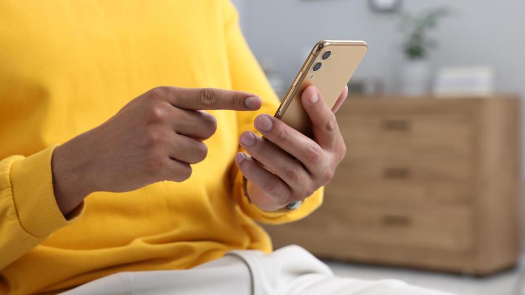 Un hombre mandando un mensaje, en una imagen de Shutterstock.