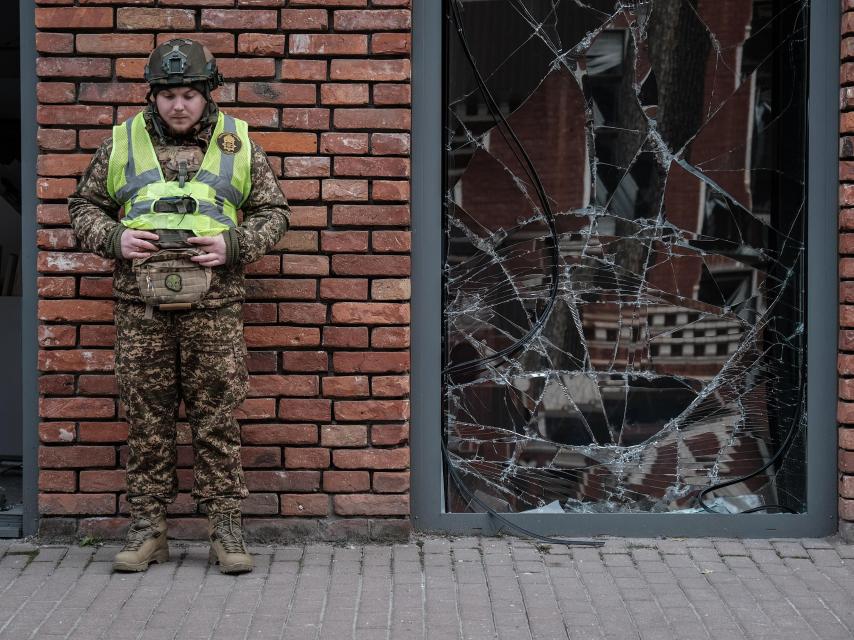 Un soldado trabaja en la zona afectada por el bombardeo que Rusia lanzó contra el centro administrativo de la ciudad de Járkiv.