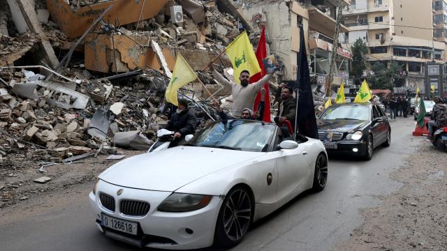 Hombres con las banderas de Hezbolá recorren los suburbios del sur de Beirut.