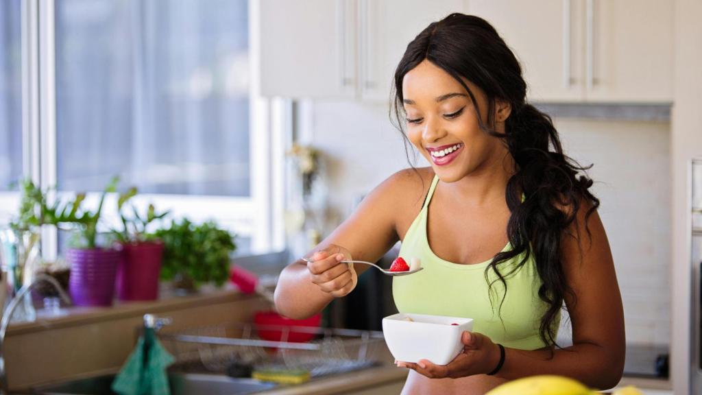 Mujer comiendo fruta.