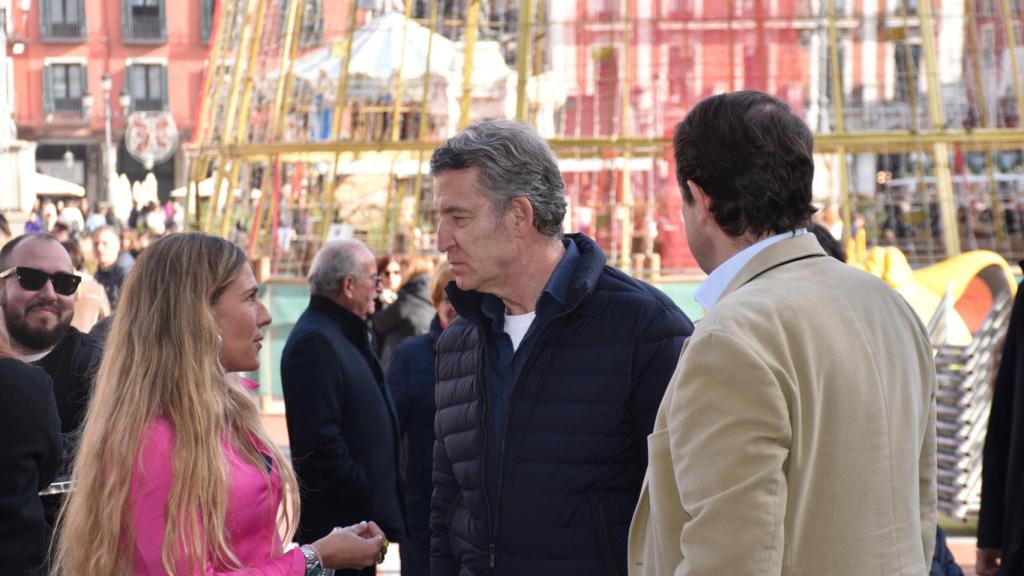 Alberto Núñez Feijóo charla con una chica en la Plaza Mayor de Valladolid, ante la mirada de Alfonso Fernández Mañueco