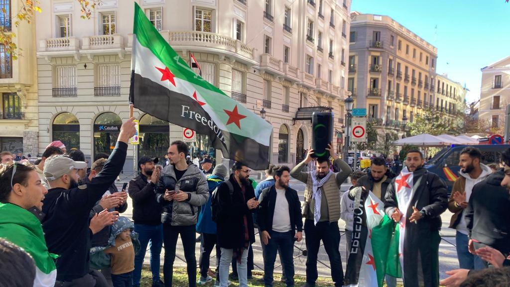 Simpatizantes de los rebeldes celebran la caída de Bashar al Asad frente a la embajada de Siria en Madrid, este sábado.