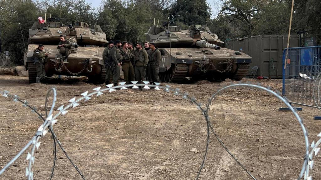 Soldados israelíes se reúnen junto a tanques en los Altos del Golán ocupados por Israel, cerca de la frontera con Siria, el 7 de diciembre de 2024.