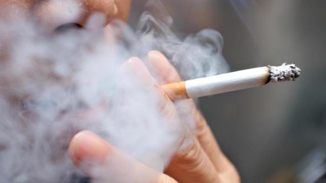 Imagen de un hombre fumando un cigarro.