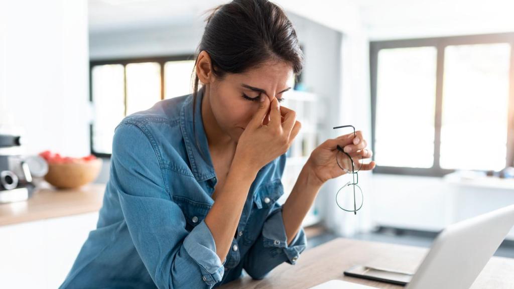 Mujer estresada trabajando en casa.