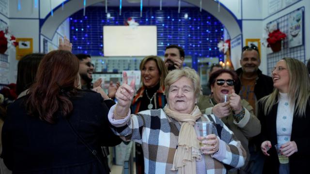 Una de las pocas andaluzas afortunadas muestra su décimo premiado.