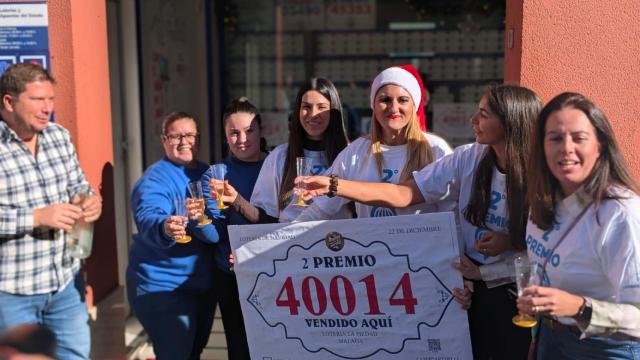 Los responsables de la Administración de Lotería de El Molinillo, en la calle Duque de Rivas, enseñan el segundo premio.