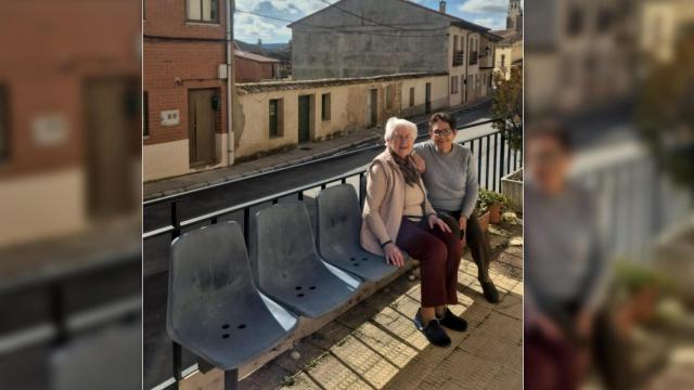 Dos vecinas de Langa de Duero sentadas en algunos de los antiguos asientos del Camp Nou repartidos por el pueblo