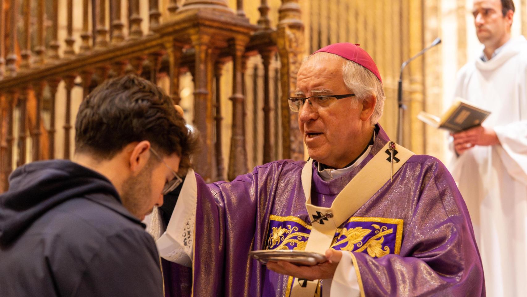 El arzobispo de Sevilla, José Ángel Saiz Meneses marca con la señal de la cruz a uno de los feligreses.