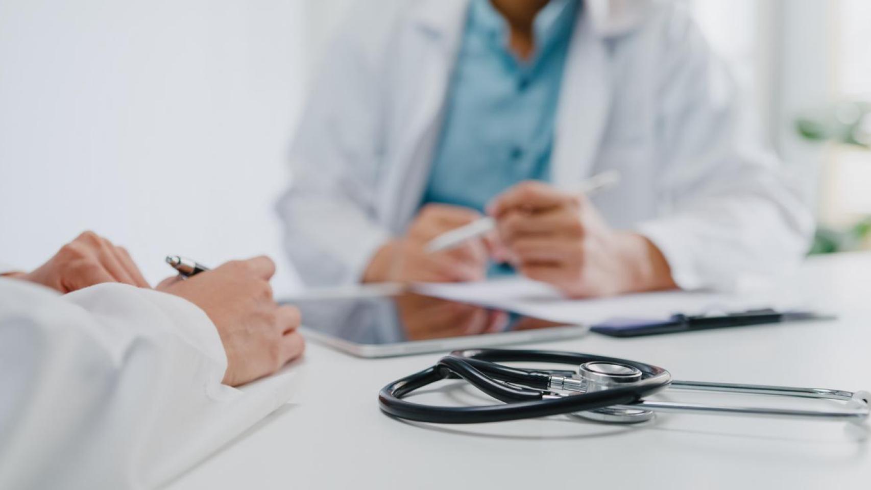 Médicos revisan un informe en la sala de reuniones de una clínica.