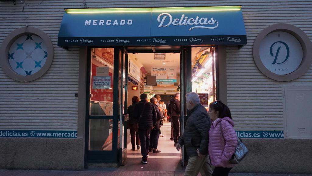 Vecinos del barrio de Las Delicias entrando a su mercado situado en el paseo comercial.