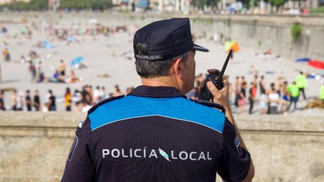 Agente de la Policía Local frente a la playa del Orzán en la tarde de San Juan.