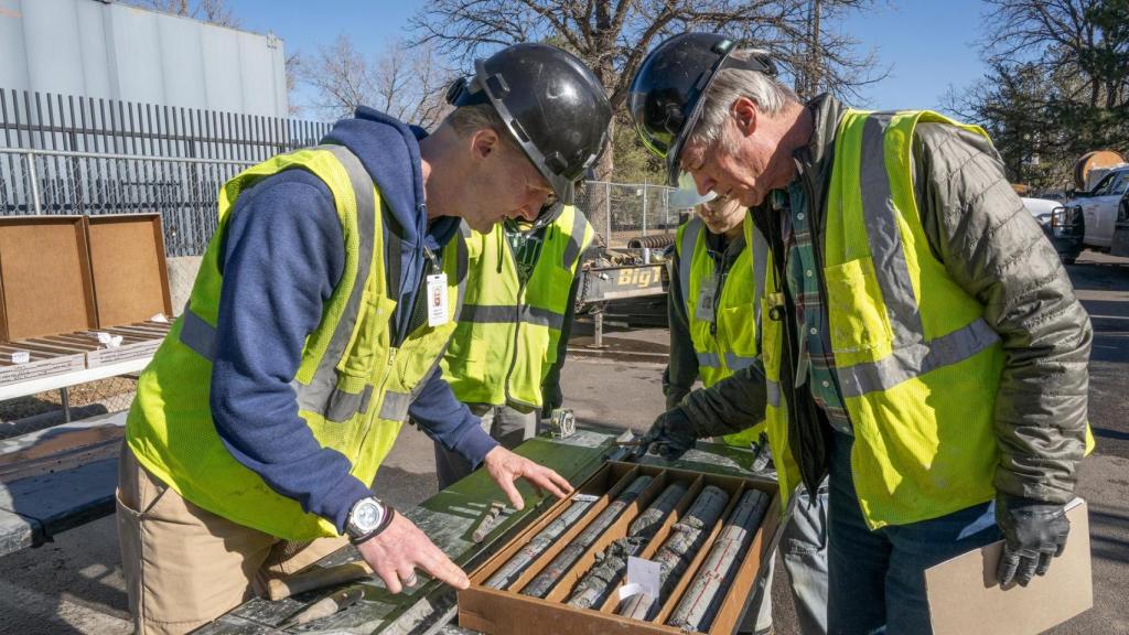 El Dr. James Hagadorn, curador de Ciencias de la Tierra, y el Dr. Bob Raynolds, investigador asociado, examinan núcleos científicos en el estacionamiento del Museo de Naturaleza y Ciencia de Denver.